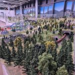 Interactive miniature world with forests, funfair rides, and moving trains at Small Worlds, Dubai's hidden gem indoor family attraction in Expo City.