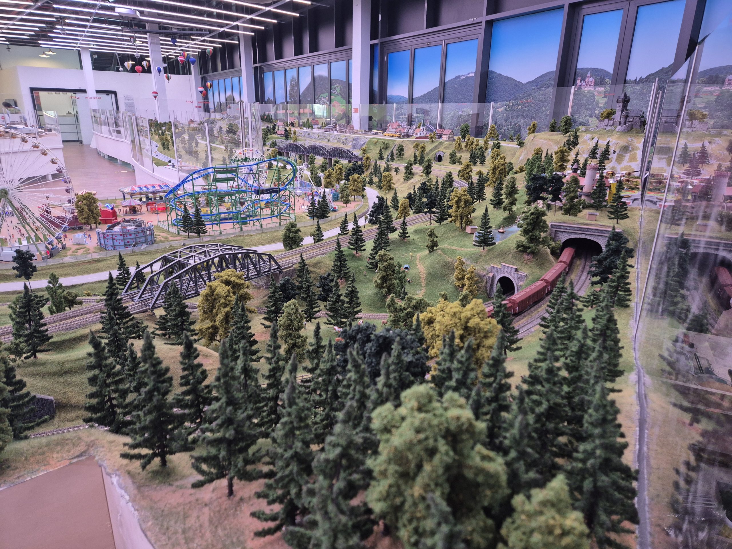 Interactive miniature world with forests, funfair rides, and moving trains at Small Worlds, Dubai's hidden gem indoor family attraction in Expo City.