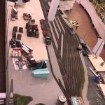 Construction of the Mega City section at Small Worlds Dubai, showing model train tracks, miniature buildings, and early-stage landscape design.